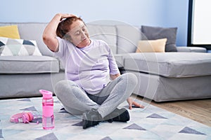 Senior woman smiling confident stretching neck at home