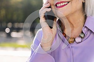 senior woman smiling happy talking by mobile phone