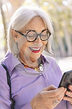 senior woman smiling happy using mobile phone