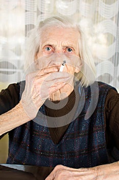 Senior woman smoking a cigarette