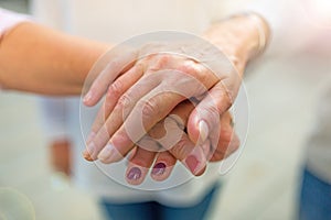 Senior woman stacking hands