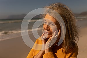 Senior woman standing on the beach