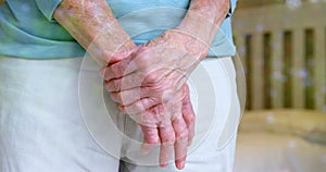 Senior woman standing hand on hand at home 4k