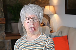 Senior woman sticking out tongue