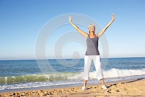 Senior Woman Stretching On Beach