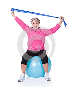 Senior woman stretching exercising equipment