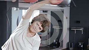 Senior woman stretching out in fitness room, mature, exercise, yoga