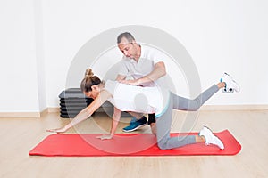 Senior woman stretching with physiotherapist