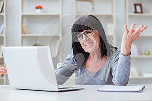 The senior woman struggling at computer