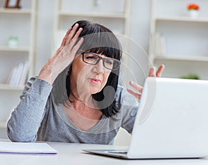 Senior woman struggling at computer