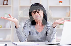 Senior woman struggling at computer