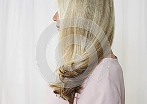 Senior woman in studio profile face obscured by hair