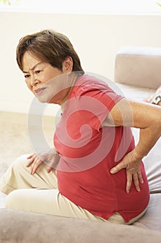 Senior Woman Suffering From Back Pain At Home