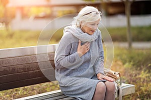 Senior Woman Suffering From Chest Pain