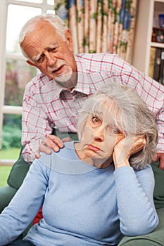 Senior Woman Suffering From Depression Comforted By Husband