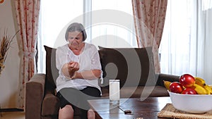 Senior woman suffering from elbow pain at home