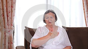 Senior woman suffering from heartache at home