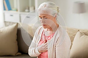 Senior woman suffering from heartache at home