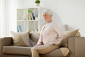 Senior woman suffering from pain in back at home