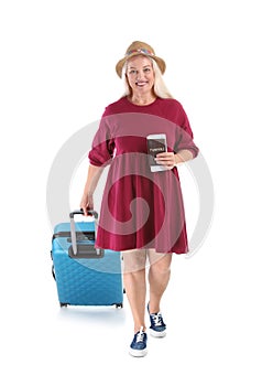 Senior woman with suitcase and passport