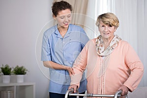 Senior woman and supporting nurse photo
