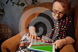 Senior woman surfing the internet on a tablet