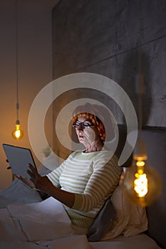 Senior woman surfing the net on tablet computer