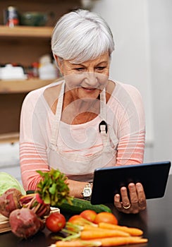 Senior woman, tablet and vegetables for cooking wholesome, healthy and nutritional food at home. Retired lady