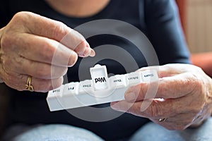 Senior Woman Taking Medication From Pill Box photo