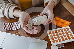 Senior woman taking pills from a bottle