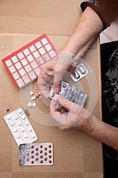 Senior Woman Taking Prescription Medicine and Organizing Pill Box