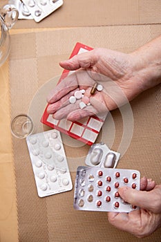 Senior Woman Taking Prescription Medicine and Organizing Pill Box