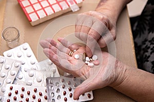 Senior Woman Taking Prescription Medicine and Organizing Pill Box