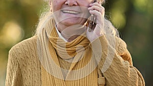 Senior woman talking on cell phone, favorable tariffs for elderly, roaming
