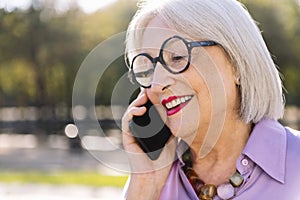 senior woman talking happy by mobile phone