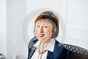 Senior woman talking with headset at the office