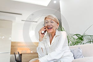 Senior woman talking on her mobile phone. Senior woman has a happy conversation at cellphone. Smiling senior woman using phone