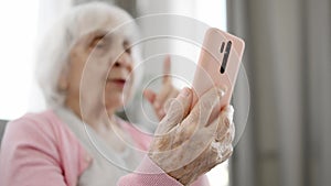 Senior Woman Talking With Video Connection Via Smartphone