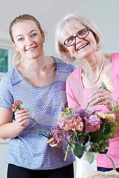 Senior Woman With Teacher In Flower Arranging Class