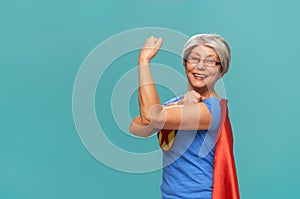Senior woman on teal background