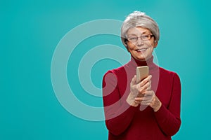 Senior woman on teal background
