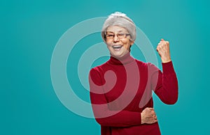 Senior woman on teal background