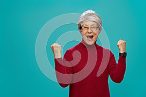 Senior woman on teal background