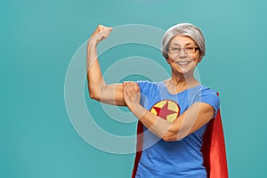 Senior woman on teal background