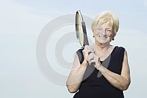 Senior woman with tennis racket