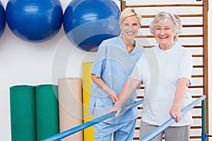 Senior woman and therapist smiling at camera