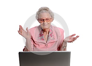 Senior Woman Throwing Hands in Front of Laptop