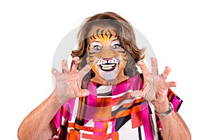 Senior woman with tiger face-paint