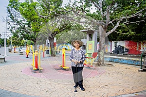 Senior woman tourist at the Macondo Linear Park in Aracataca the birthplace of Nobel Prize Gabriel Garcia Marquez