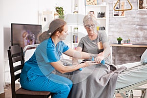 Senior woman training with physiotherapist in nursing home